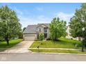 Beautiful two-story home with a well-maintained lawn and a driveway leading to the garage at 8336 Bent Oak Dr, Indianapolis, IN 46236