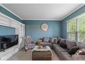 Comfortable living room with a plush gray sectional sofa and ample natural light at 8336 Bent Oak Dr, Indianapolis, IN 46236