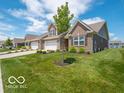 A home with a lush green lawn and beautiful landscaping create a welcoming outdoor space at 8866 Twain Ln, Indianapolis, IN 46239