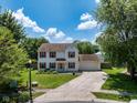 Charming two-story home features red shutters, manicured lawn, two-car garage and long driveway at 901 Mallory Pkwy, Franklin, IN 46131