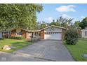 Well maintained home with a large tree in the front yard and driveway at 911 Glendale Dr, Lebanon, IN 46052