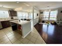 Open floor plan with a kitchen featuring an island and breakfast nook, leading to a living area or playroom at 9628 Gull Lake Dr, Indianapolis, IN 46239