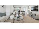 Bright and airy living room with stylish decor and an open layout connecting to the kitchen and dining area at 9855 Oakmont E E Dr, Pendleton, IN 46064
