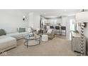 Bright and inviting living room with modern furnishings and an open-concept design leading to the kitchen at 9855 Oakmont E E Dr, Pendleton, IN 46064
