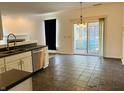 Eat-in kitchen with stainless steel appliances and sliding doors to the backyard at 9987 Rainbow Falls Ln, Fishers, IN 46037