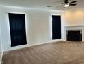 Inviting living room with a fireplace, ceiling fan, and carpeted floors at 9987 Rainbow Falls Ln, Fishers, IN 46037