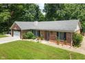 Aerial view of a brick home with a well-maintained lawn and surrounding trees at 10519 N Antioch Rd, Mooresville, IN 46158