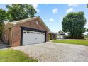 Brick home with a white garage door and a long gravel driveway at 10519 N Antioch Rd, Mooresville, IN 46158