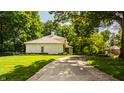 Stunning home with a well-manicured lawn, lovely landscaping, and a tree-lined driveway leading to tranquility at 110 Bow Ln, Indianapolis, IN 46220
