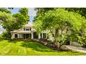 Beautiful home featuring a well-kept lawn, vibrant flower beds, and shade trees providing a peaceful setting at 110 Bow Ln, Indianapolis, IN 46220