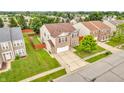 Aerial view of home showcasing its landscaped yard and surrounding neighborhood in a suburban setting at 1449 Danielle Dr, Indianapolis, IN 46231