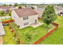 Aerial view of a fenced backyard with a patio and garden, surrounded by lush greenery and neighborhood homes at 1449 Danielle Dr, Indianapolis, IN 46231
