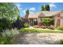 Landscaped front yard with a black aluminum fence featuring a walkway to the entry door at 1481 Wrenwood Dr, Columbus, IN 47201