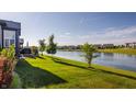 Lush backyard with a view of the serene lake in a Gathering-friendly neighborhood at 15600 Woodford Dr, Westfield, IN 46074