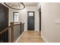 Bright hallway with hardwood floors, iron railing, and neutral wall colors at 15600 Woodford Dr, Westfield, IN 46074