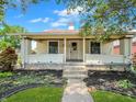 Inviting front porch with brick pillars and concrete steps leading to the entrance at 1602 California St, Columbus, IN 47201