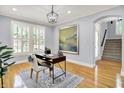 Bright home office featuring hardwood floors, a stylish desk, a large window, and modern decor at 2263 Glebe St, Carmel, IN 46032