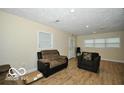 Living room with neutral walls, wood-look floors, and comfortable seating at 2305 Barnor Dr, Indianapolis, IN 46219