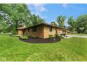 Brick home with well-maintained landscaping, showcasing curb appeal and a spacious yard at 2750 Chamberlin Dr, Indianapolis, IN 46227