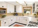 Bright kitchen with white cabinetry, modern appliances, and a window with a view at 2922 E 62Nd St, Indianapolis, IN 46220