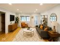Bright living room with stylish furniture, hardwood floors and an accent rug at 2922 E 62Nd St, Indianapolis, IN 46220