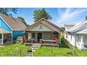 Charming bungalow style house with brick porch columns and a quaint entryway at 3042 Newton Ave, Indianapolis, IN 46201