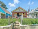 Shot of the front exterior of a bungalow-style home featuring a quaint front porch at 3042 Newton Ave, Indianapolis, IN 46201