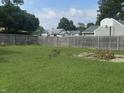 Spacious backyard with grass, wood fence and basketball hoop is a great space to play and relax at 3143 Carson Ave, Indianapolis, IN 46227