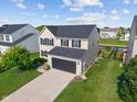 An aerial view of a home featuring a well-kept yard and a long driveway at 3230 Hemlock St, Whiteland, IN 46184