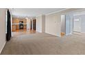 Spacious living room with plush carpeting leading into an open-concept kitchen at 3230 Hemlock St, Whiteland, IN 46184