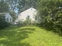 Spacious backyard featuring ample greenery, offering privacy and potential at 3429 Kinnear Ave, Indianapolis, IN 46218