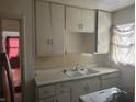 Classic kitchen featuring cabinetry, countertop space, and a sink at 3429 Kinnear Ave, Indianapolis, IN 46218