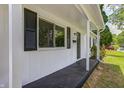A cozy covered front porch with black trim offers an inviting entryway at 3617 Woodcliff Dr, Indianapolis, IN 46203