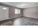 Bright living room with hardwood floors, fresh paint, and natural light at 3617 Woodcliff Dr, Indianapolis, IN 46203