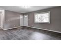 Bright living room with hardwood floors, fresh paint, and natural light at 3617 Woodcliff Dr, Indianapolis, IN 46203