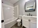 Beautifully updated bathroom with new fixtures, white vanity, and a shower-tub combo at 405 N Bradley Ave, Indianapolis, IN 46201
