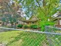 Exterior view showing the fenced front yard and a covered porch at 434 N Bradley Ave, Indianapolis, IN 46201