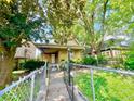 Exterior view showing a fenced front yard and a covered porch entrance at 434 N Bradley Ave, Indianapolis, IN 46201