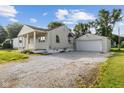 This home has a long gravel driveway leading to a detached garage and backyard at 4749 W Smith Valley Rd, Greenwood, IN 46142