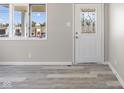 Bright entryway with stylish vinyl floors, decorative front door and ample natural light at 4749 W Smith Valley Rd, Greenwood, IN 46142