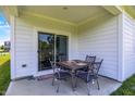 Cozy covered patio with a charming table and chairs set for relaxing or outdoor dining at 5120 Woodhurst Ln, Indianapolis, IN 46239