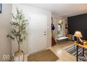Inviting entryway with stylish decor and a decorative tree, leading to a beautifully decorated living area at 5504 Grassy Bank Dr, Indianapolis, IN 46237