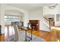 Inviting living room with hardwood floors, neutral colors, and staircase access at 5761 Coopers Hawk Dr, Carmel, IN 46033