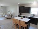 Spacious eat-in kitchen, with an island, flowing into a living room with comfortable furnishings at 7232 Moultrie Dr, Indianapolis, IN 46217