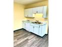 Updated kitchen with stylish white cabinets, modern countertops, and new flooring at 803 S Pershing Dr, Muncie, IN 47302