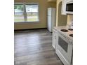 Bright kitchen featuring new floors, modern appliances, and ample counter space at 803 S Pershing Dr, Muncie, IN 47302
