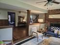 Cozy living area featuring hardwood floors, a brick fireplace, and comfortable seating area at 8423 Mud Creek Rd, Indianapolis, IN 46256