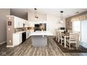 Bright kitchen features white cabinets, black appliances, a large island, and an adjacent dining area at 8514 Midsummer Dr, Indianapolis, IN 46239