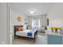 Bright bedroom with window seat, stylish lighting, and playful decor at 920 State St, Shelbyville, IN 46176
