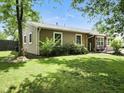 Picture of home's backyard, showing a well-maintained lawn, mature trees, and exterior of home at 1039 Eastlawn Dr, Whiteland, IN 46184